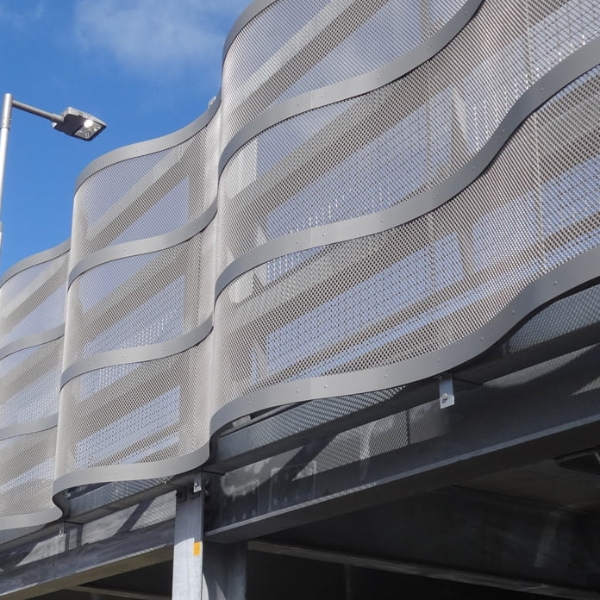 停车场安装着波浪形状的钢板网幕墙。